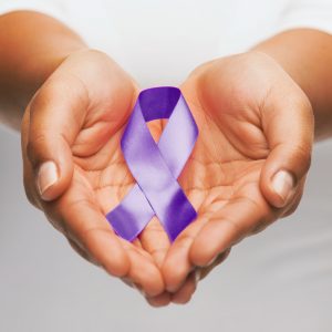 two hands holding a purple ribbon